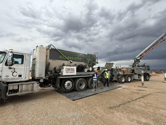 Volumetric concrete mixer truck delivering fresh concrete on site